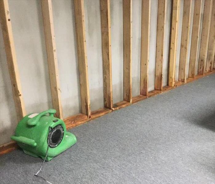 green air mover on grey carpet